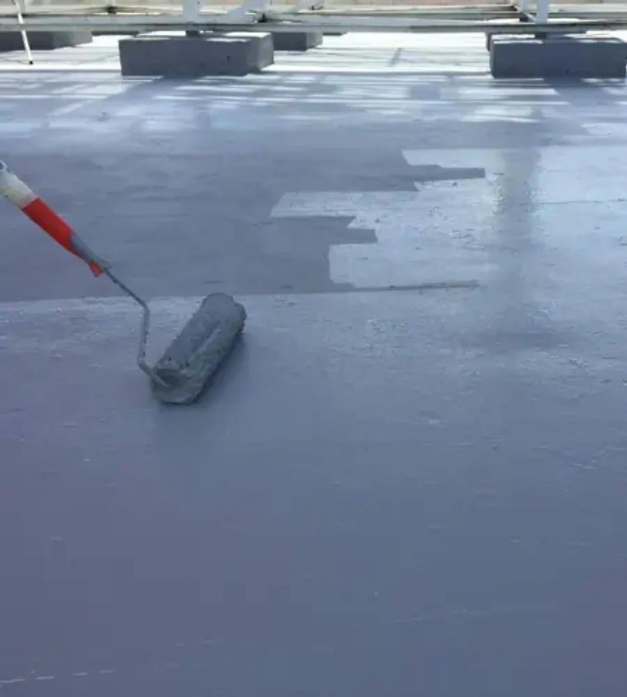 Liquid waterproofing coating on a roof